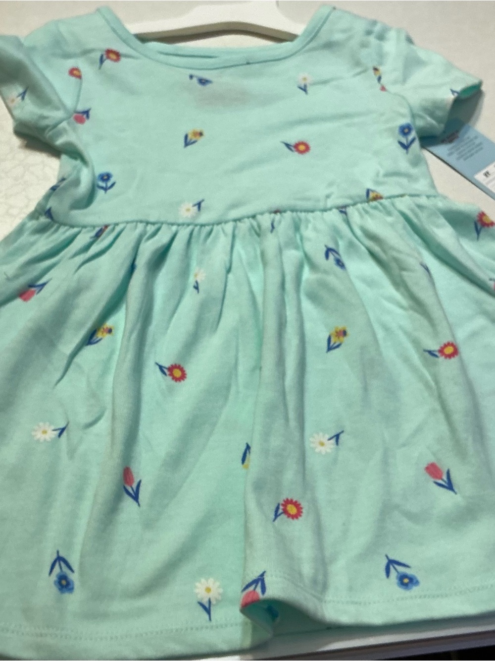 A  2T mint green dress with flowers and a short sleeved rose colored dress